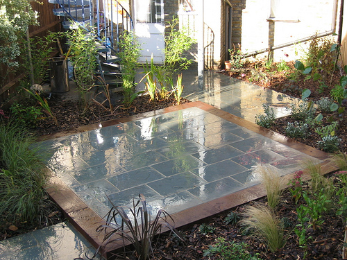 Landscape gardening ideas such as contrasting paving can change the shape and space in your garden