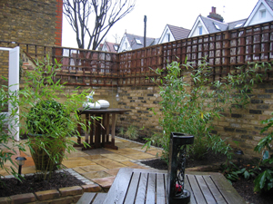 Patio garden with two distinct dining areas, seperated by a living bamboo hedge